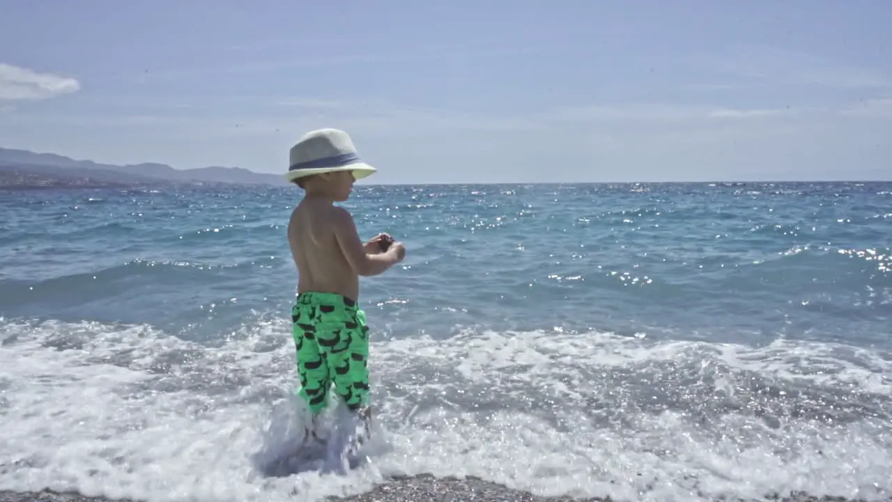 Three Years Old Child Enjoys The Sea At Kalamata Beach Greece SLOW MOTION