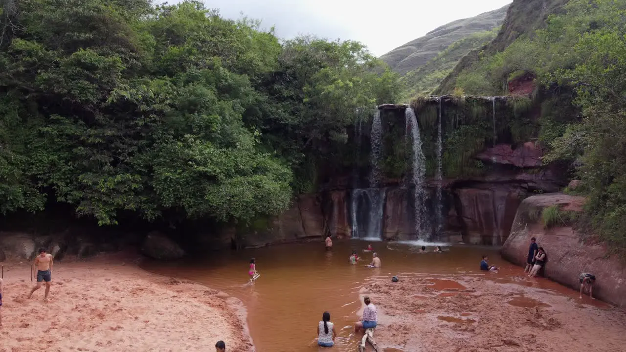 People enjoy nature at Las Cuevas Waterfall in Bolivian mountains