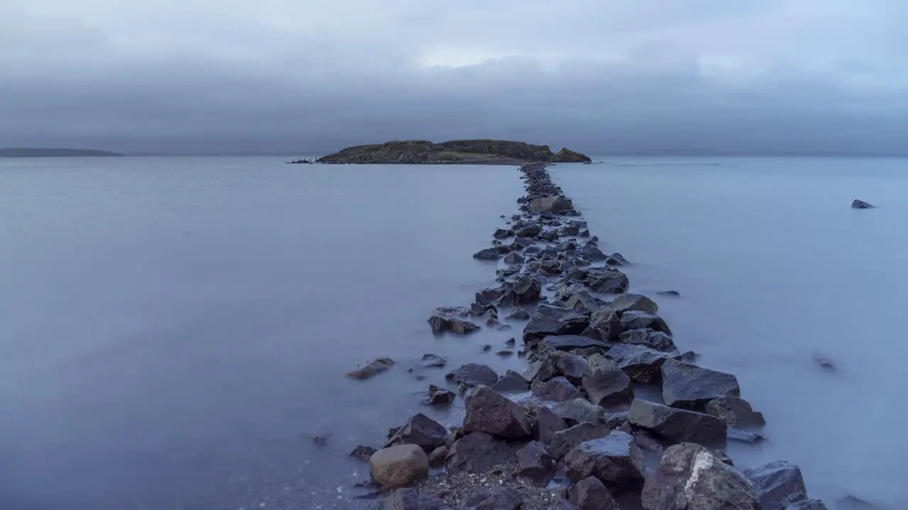 Dramatic time lapse video of rocky path leading to an island