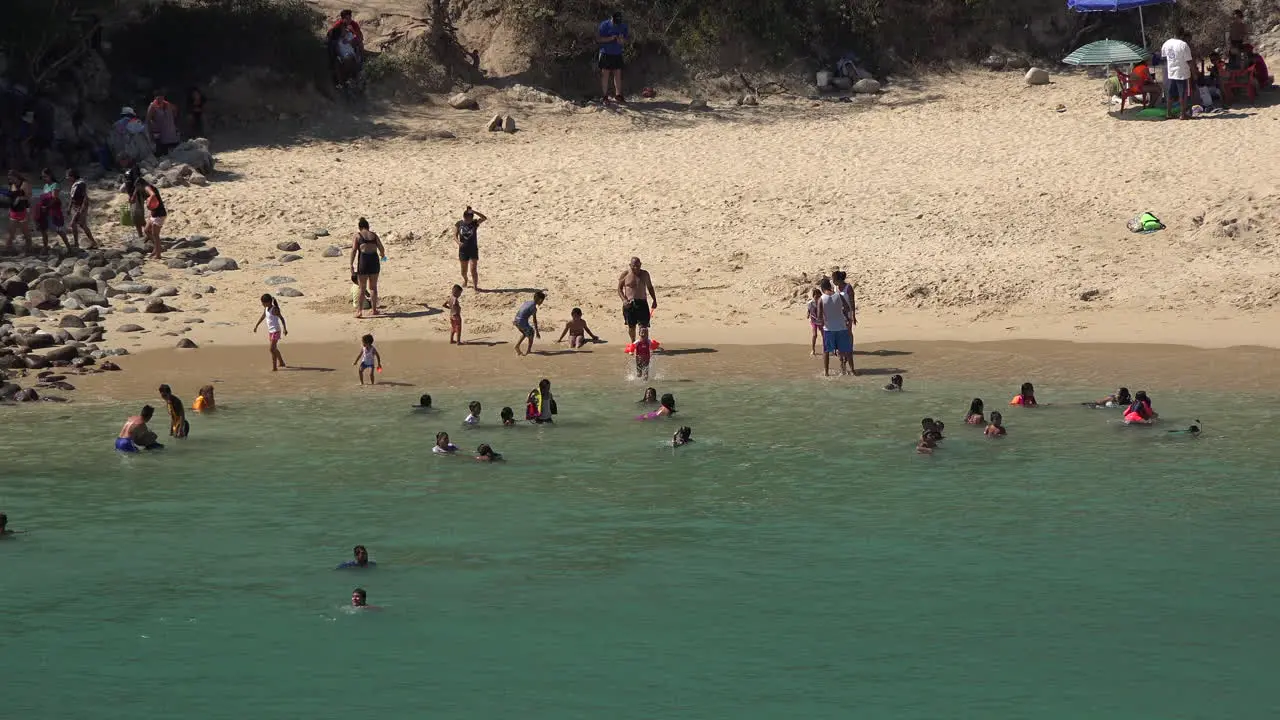 Mexico Huatulco looking down at people in water by beach