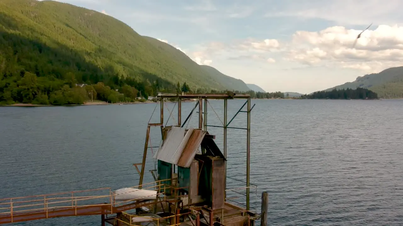 Old abandoned wharf on a lake with mountains in background