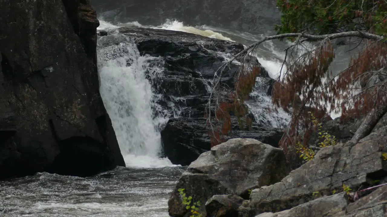 Water splashing in the distance while cascading down some stunning stones