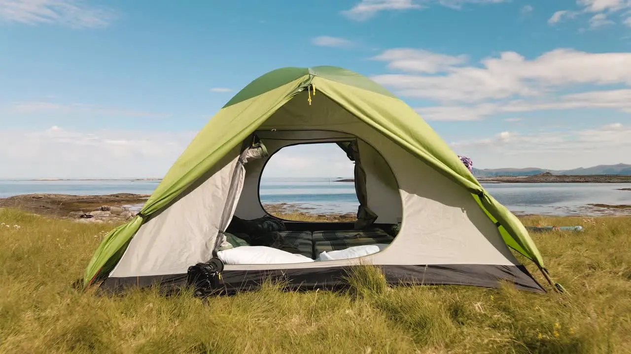 The drone is flying through a tent located on the shore of the Norwegian fjord