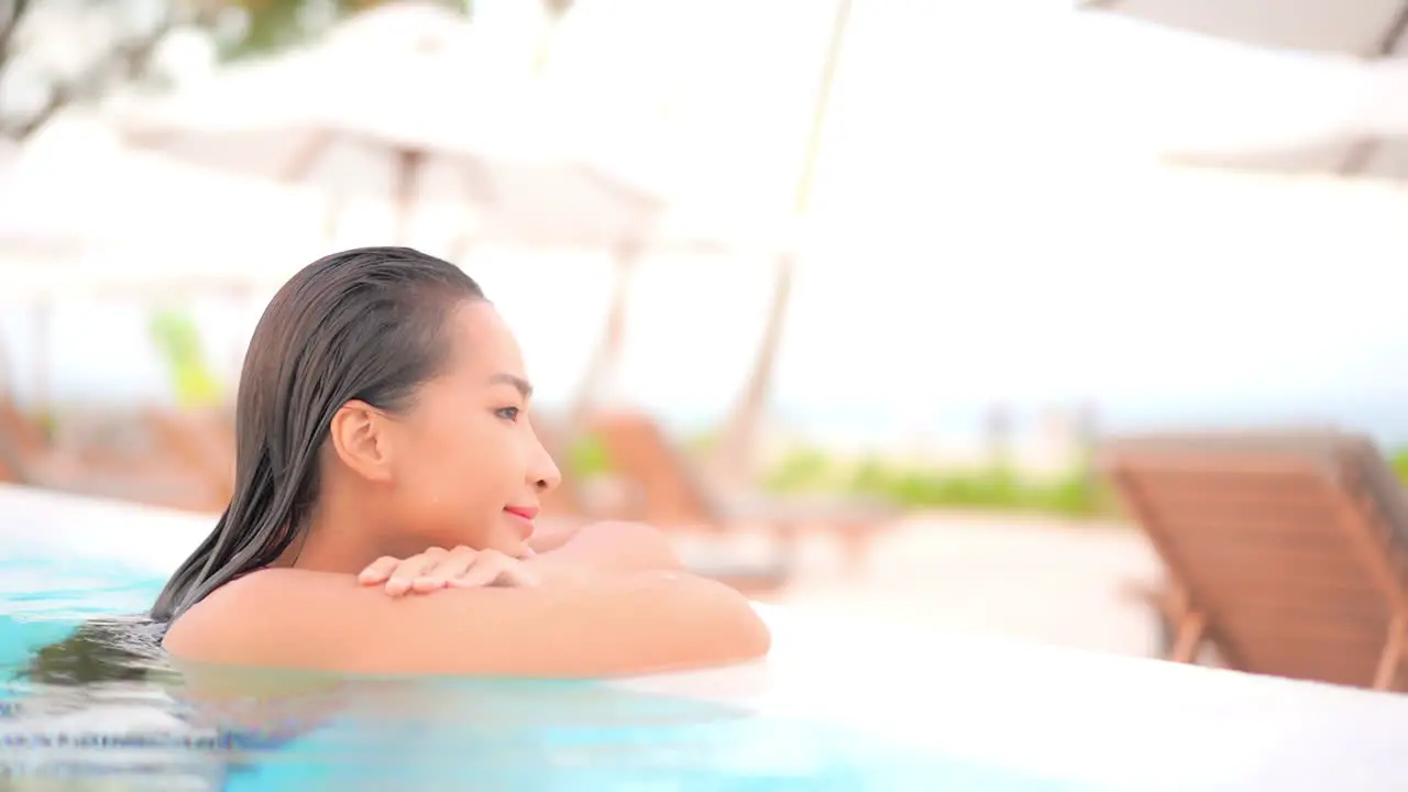 Profile of Sexy Exotic Woman Enjoying in Swimming Pool Water on Tropical Holiday Slow Motion Full Frame