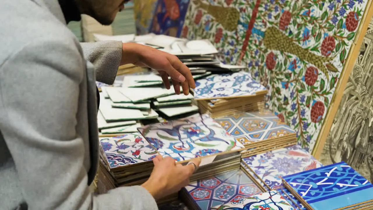 High Angle Shot of a Man Looking at Tiles