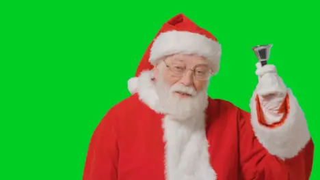 Portrait Shot of Santa Ringing Bell In Front of Green Screen