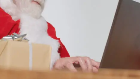 Low Angle Shot of Santa Typing On a Laptop