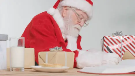 Medium Shot of Santa Sitting at Desk Writing