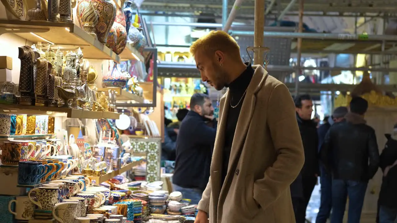 Mid Shot of a Man Looking at Cups