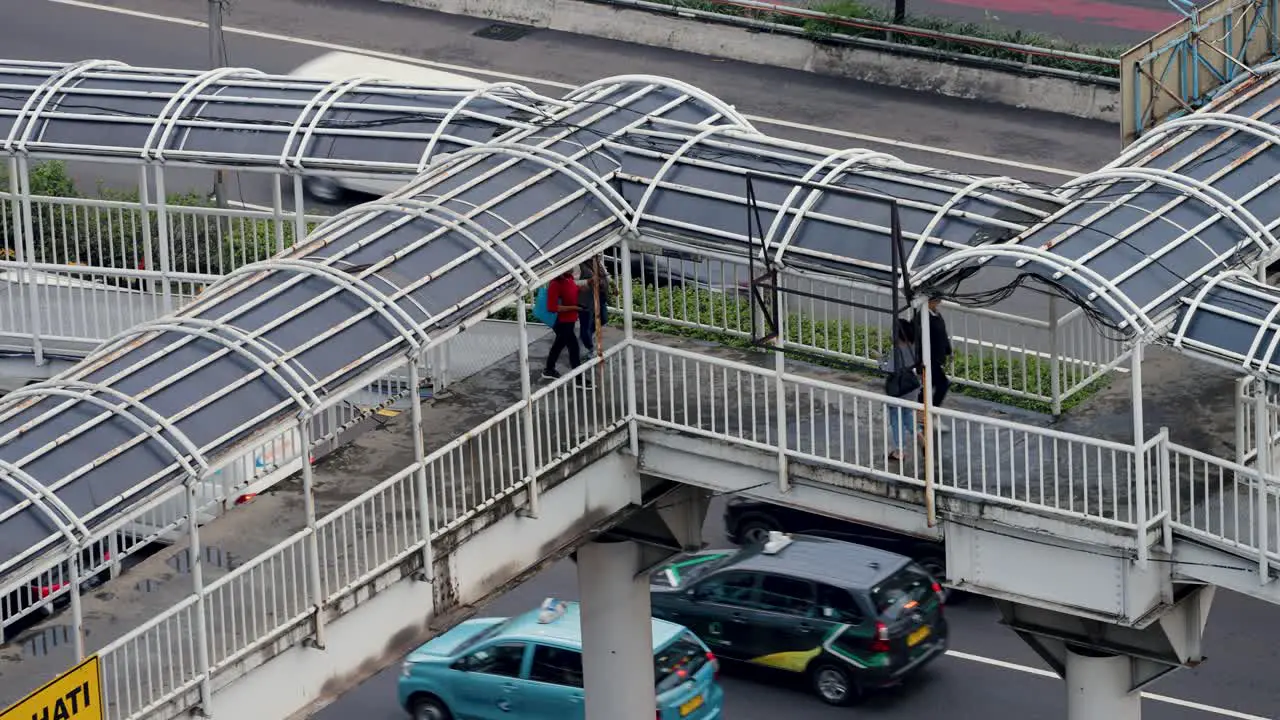 High Angle Shot of People Walking On Footbridge