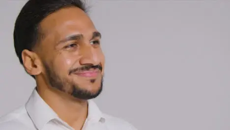 Close Up Shot of Young Man Smiling Away From Camera