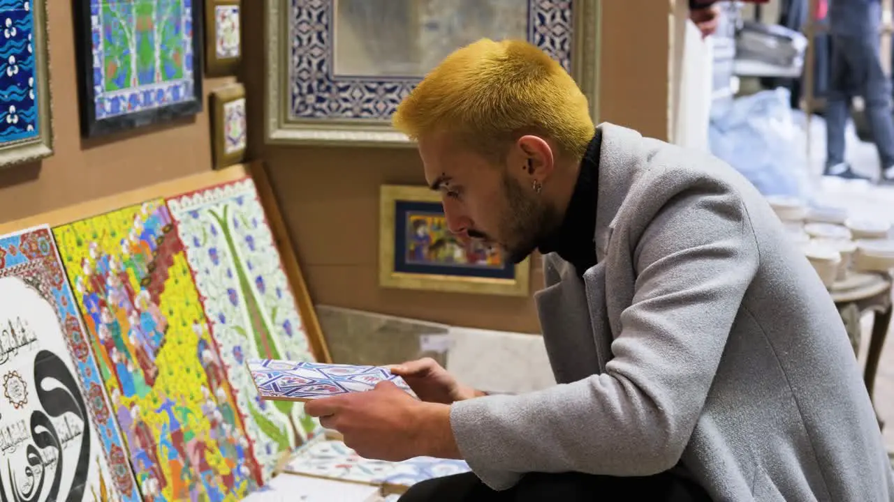 Mid Shot of Man Looking at Tiles