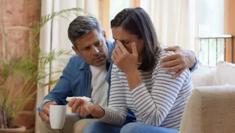 Wide Shot of a Man Attempting to Comfort Visibly Concerned Wife