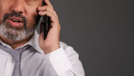 Middle Aged Businessman Having Heated Phone Call Portrait