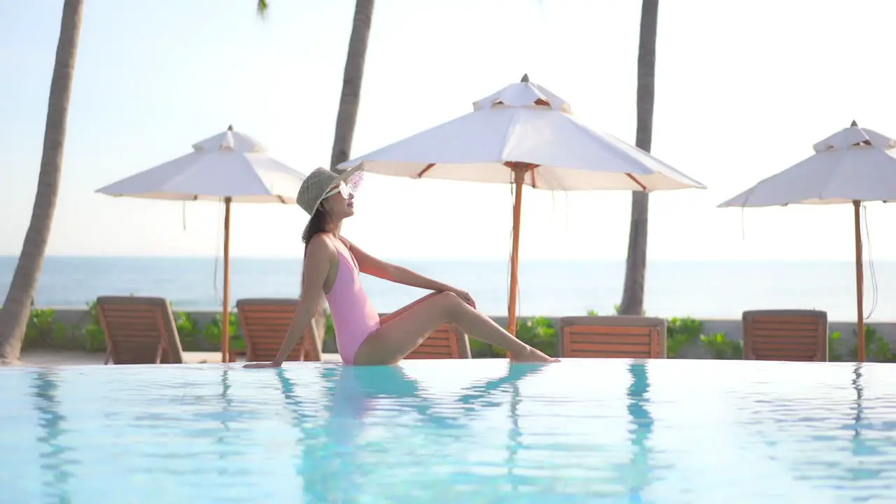 Sexy Exotic Woman at Poolside on Tropical Travel Destination Enjoying on Summer Sun Full Frame