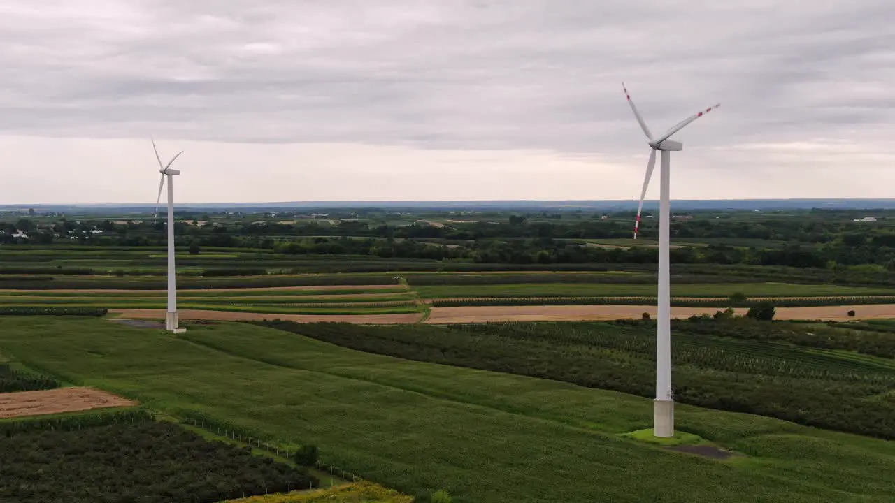 Green energy electric power is generated by wind turbines with rotating propellers