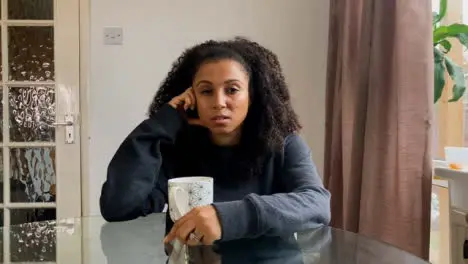 Young Woman On a Video Call Looking Visibly Depressed As She Talks to Therapist