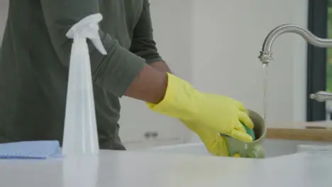 Man Cleaning Mug Under Kitchen Tap Running Water