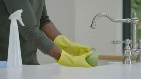 Man Cleaning Mug Under Running Water from Kitchen Tap 