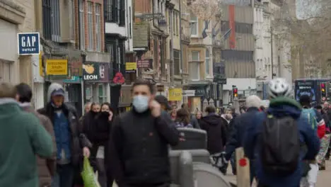 Long Shot of a Crowd of People Walking Down Busy Street In Oxford England