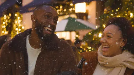 Couple In Front Of Christmas Tree In Leadenhall Market When Snowing in London