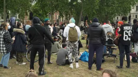 London Group of Activists Dancing to Music in Park