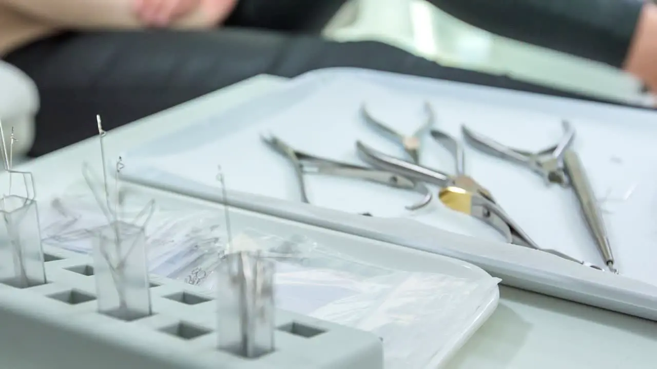 Surgical instruments required for medical pedicure lying in the tray beside the patient