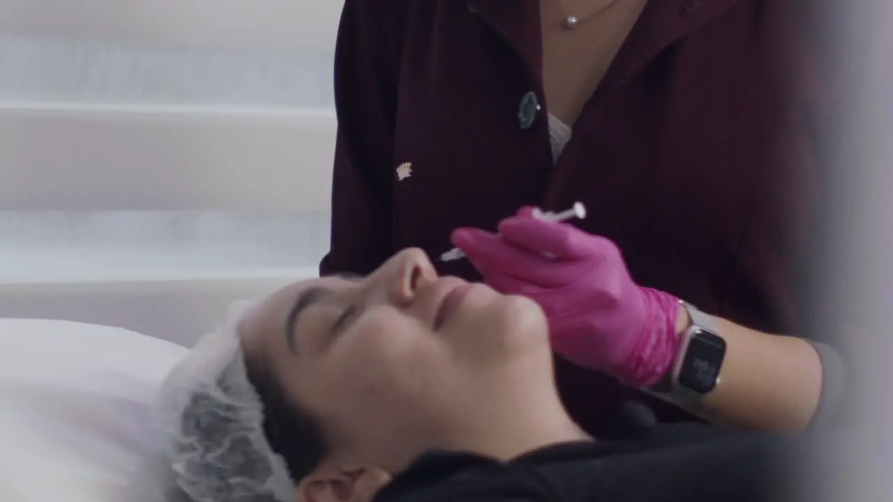 Close up patient getting botox injection inside clinic