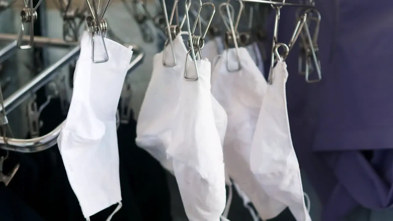 Selective focus of washed white cloth masks to dry outdoors after a week of anti COVID-19 use