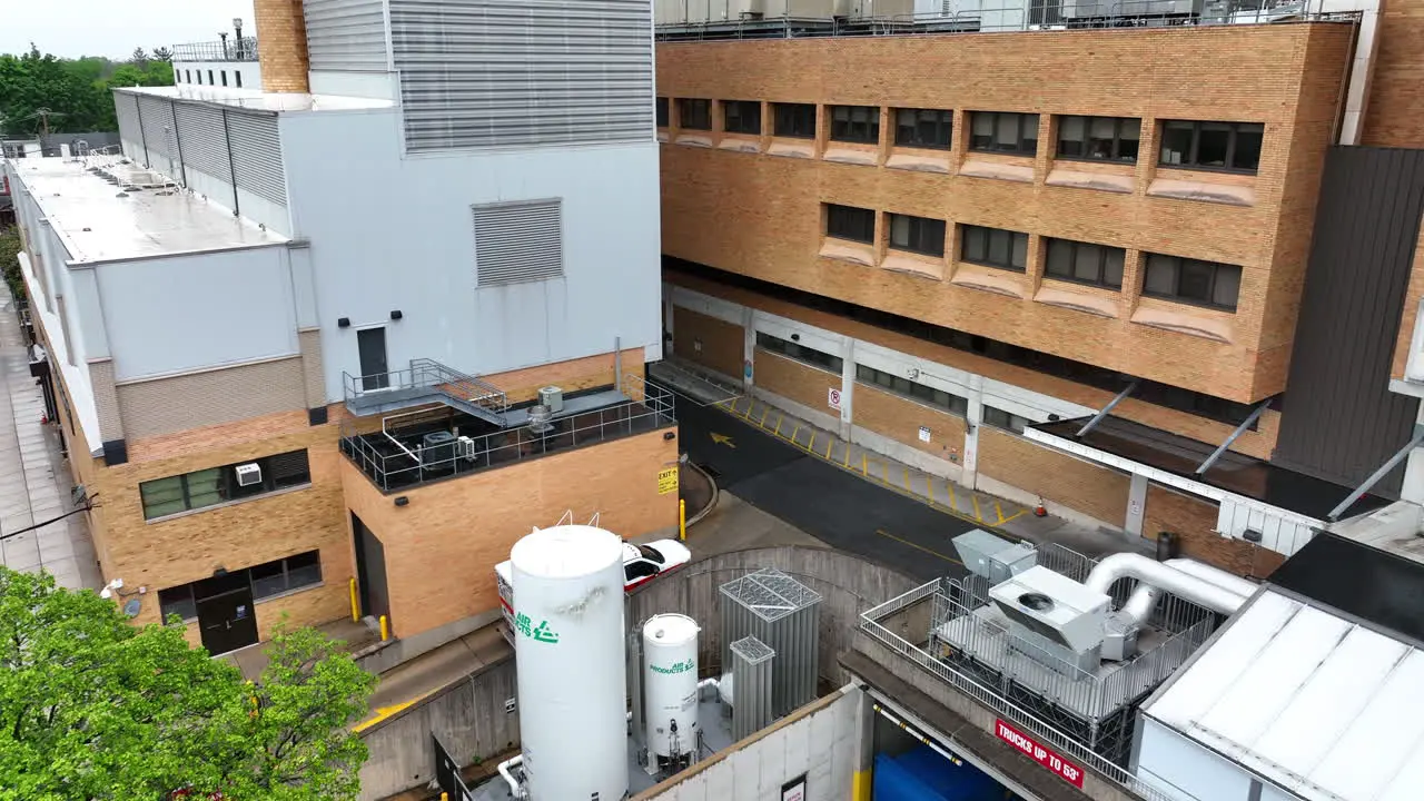 Aerial view of ambulance driving into hospital parking area