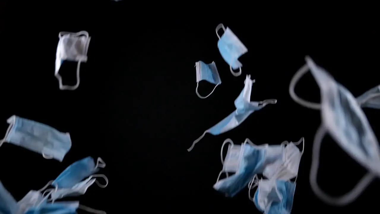 Surgical Masks Falling Against Black Background studio shot