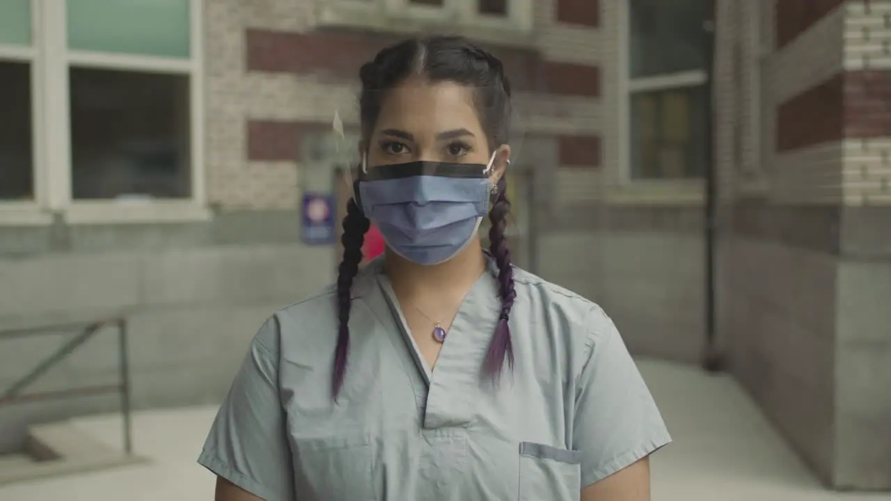 A woman looks up wearing a mask