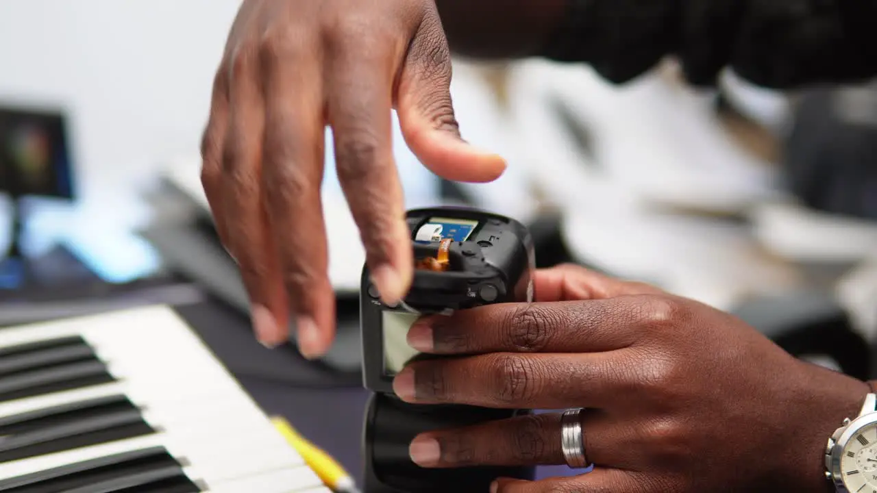 Man repairing the camera flash by replacing the bottom