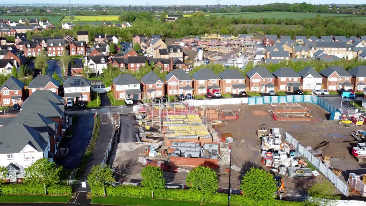 Construction site aerial view above new urban real estate housing development regeneration pull away zoom out