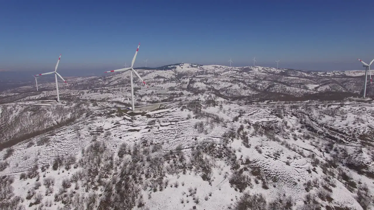 many wind turbines on top of a mountain