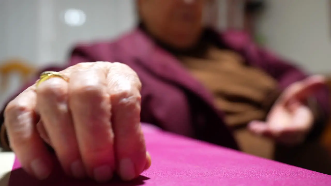 Old woman taking different pills from a table