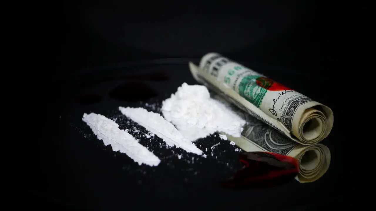 Drips Of Blood And Cocaine Powder With A Roll Of Drug Money Beside On The Turn Table studio shot