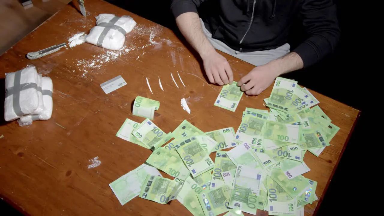 Drug Dealer Rolls 100 Euro Banknote And Snort Cocaine On The Table