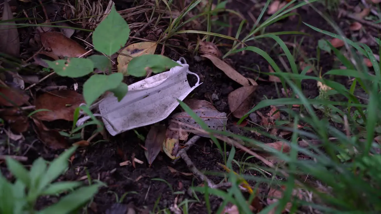 Dirty Used Face Mask Thrown On The Forest Ground close up