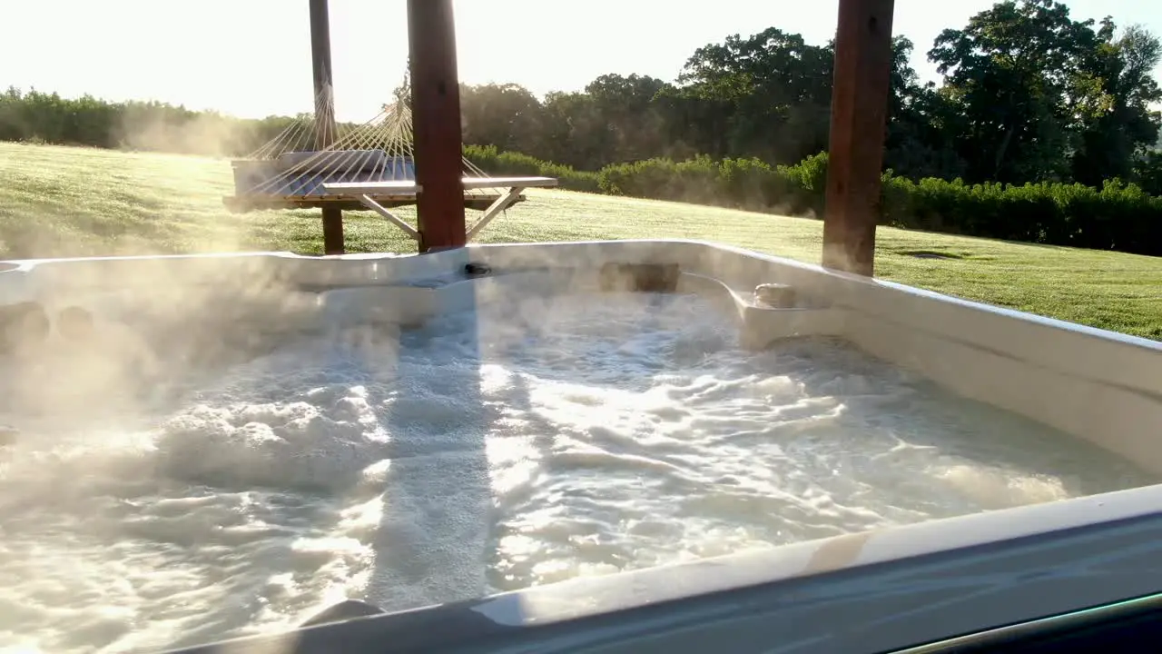 Steaming sauna hot tub pool bubbles during morning sunrise