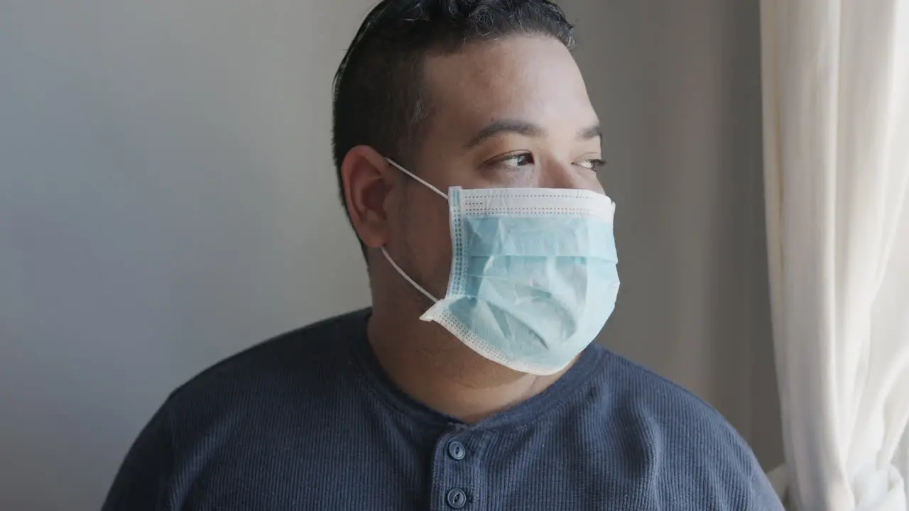 Young Hispanic Male Putting on a Face Mask