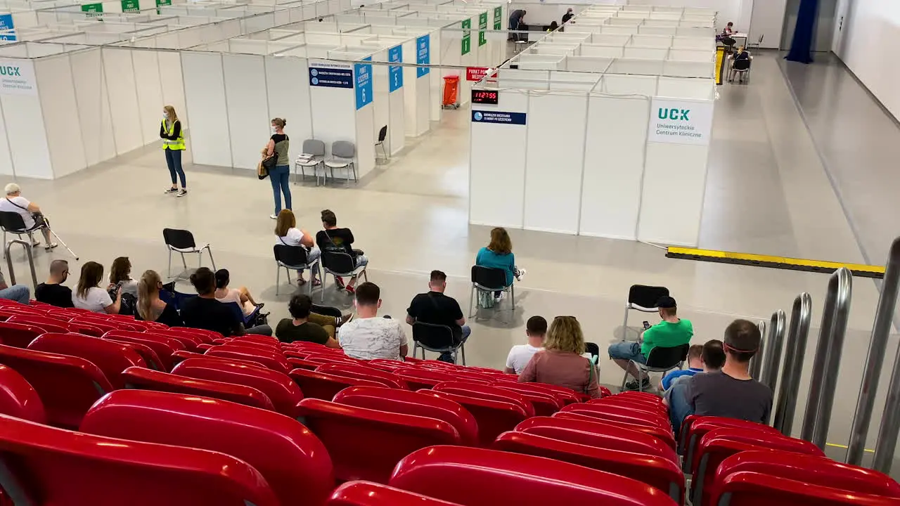 UCK Gdansk place of universal vaccination COVID-19 people waiting on red chairs after vaccination Poland