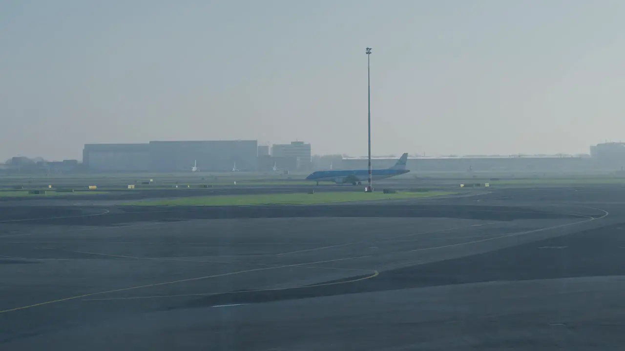 Tracking shot of a plane being taxied along the runway for takeoff at Rotterdam