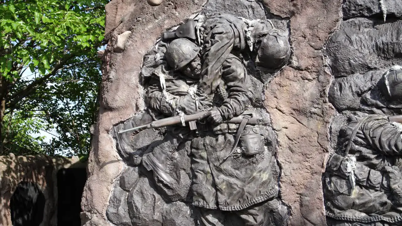 Community Veterans Memorial sculpture of soldier carrying a fallen soldier