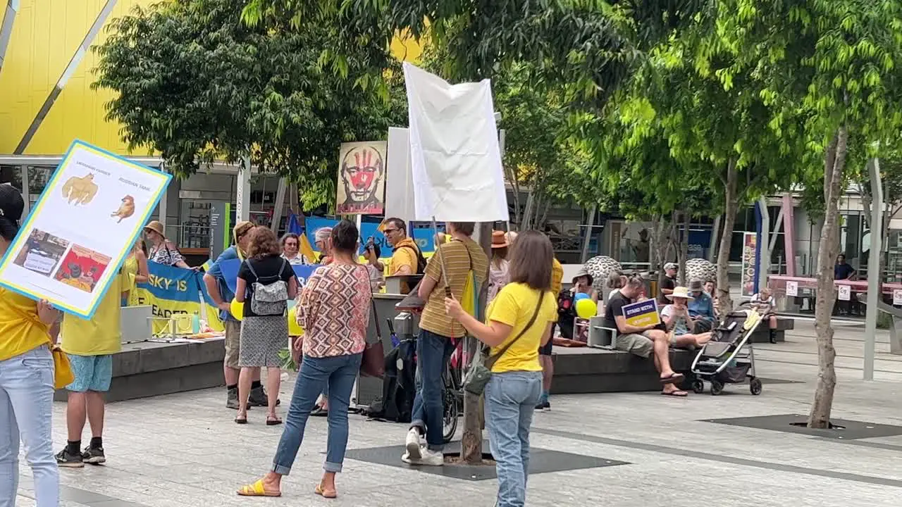 Woman holds a banner with heart shape coat of arms of Ukraine during a peaceful pacifist demonstration at Brisbane Square to call for peace as tension rise between Russian and Ukraine