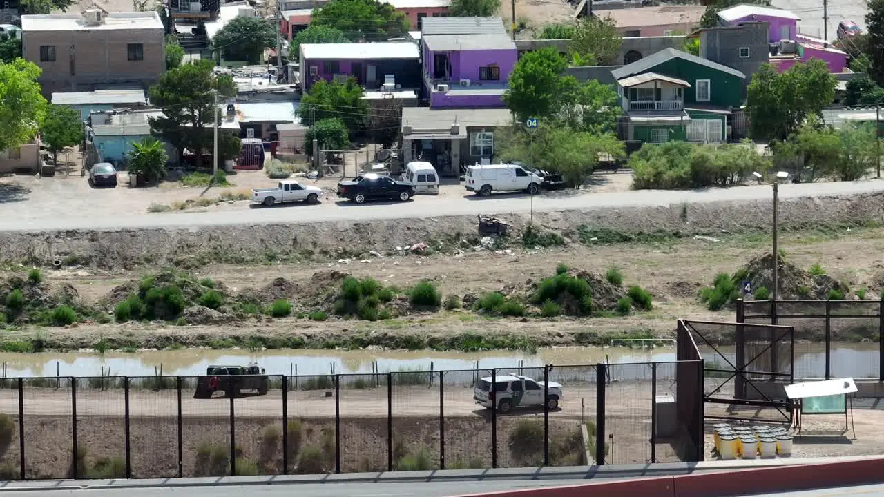 Aerial view of Border Patrol SUV and Humvee Military grade vehicle at border of Mexico and USA