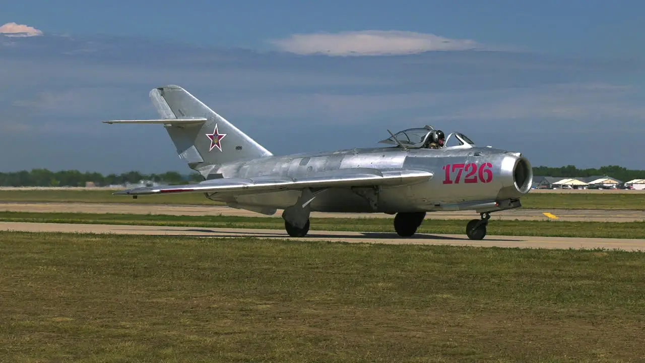 Retro fighter jet on a airfield runway sunny day in Los Angeles California USA