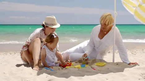 Small Family Having Fun at the Beach Sand