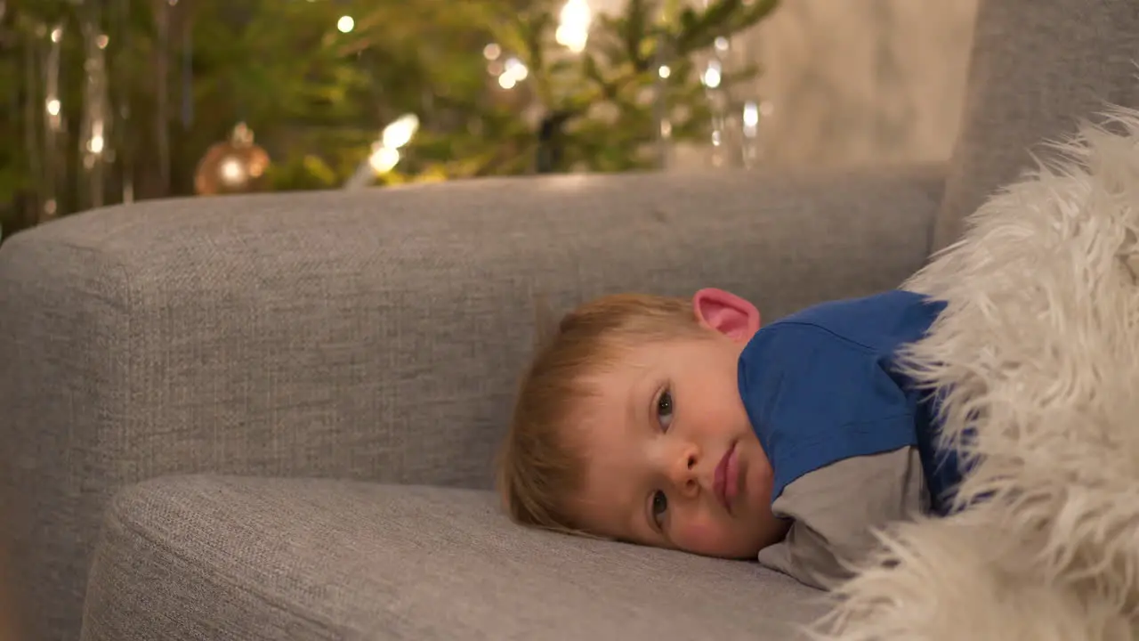 Tired kid resting after Christmas celebrations