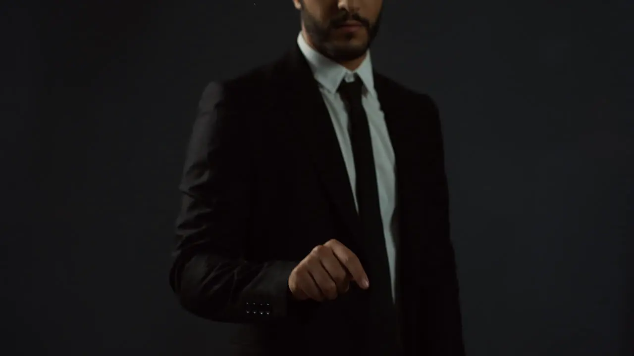 Close Up View Of Arabian Businessman Wearing Suit And Tie Scrolling And Typing With His Finger In The Air Like Having A Hologram Screen At The Office 1